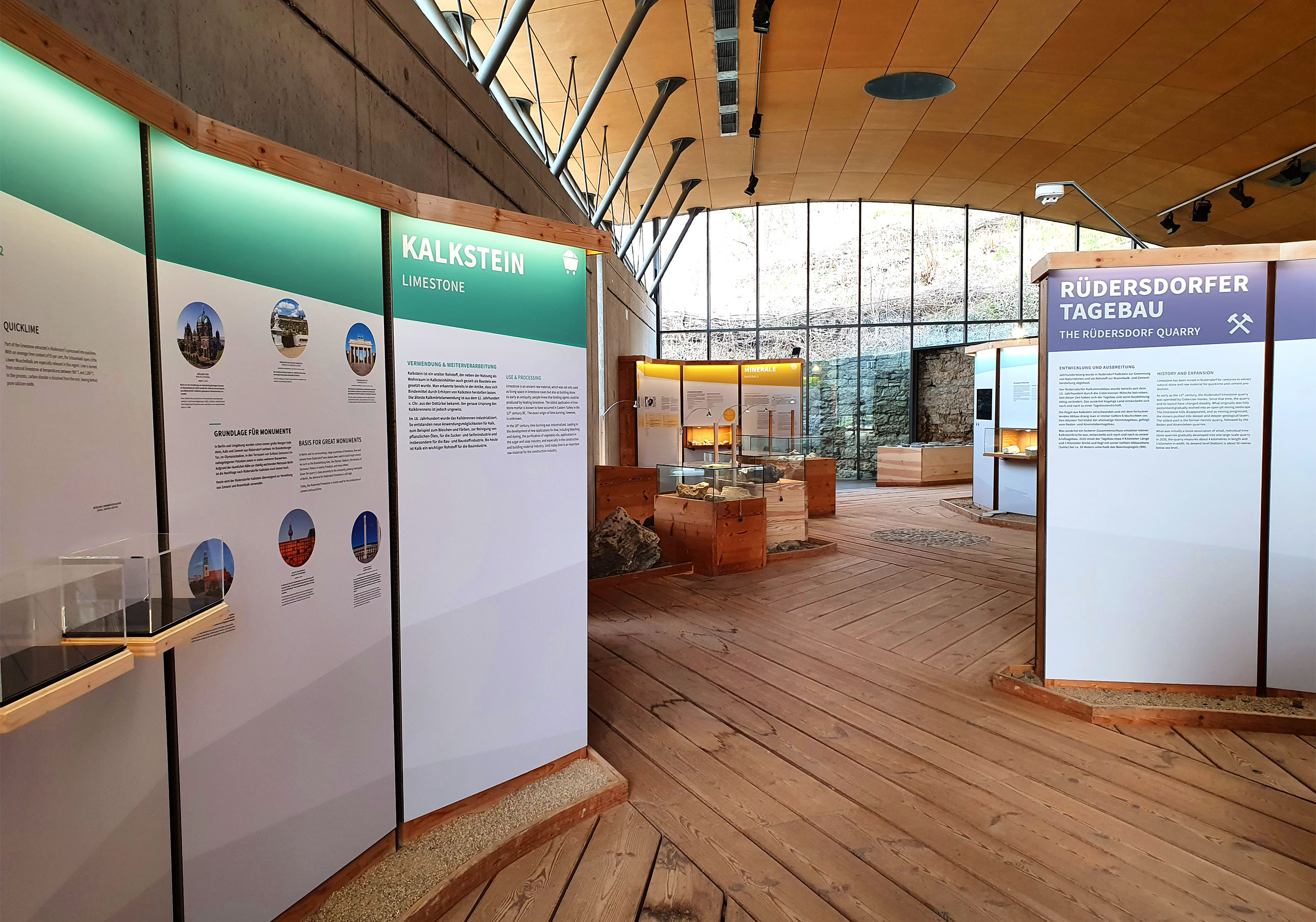 Blick in die Ausstellung mit Informationstafeln zu Kalkstein, Rüdersdorfer Tagebau und Mineralen. Jede Überschrift ist mit einer anderen Farbe gekennzeichnet.